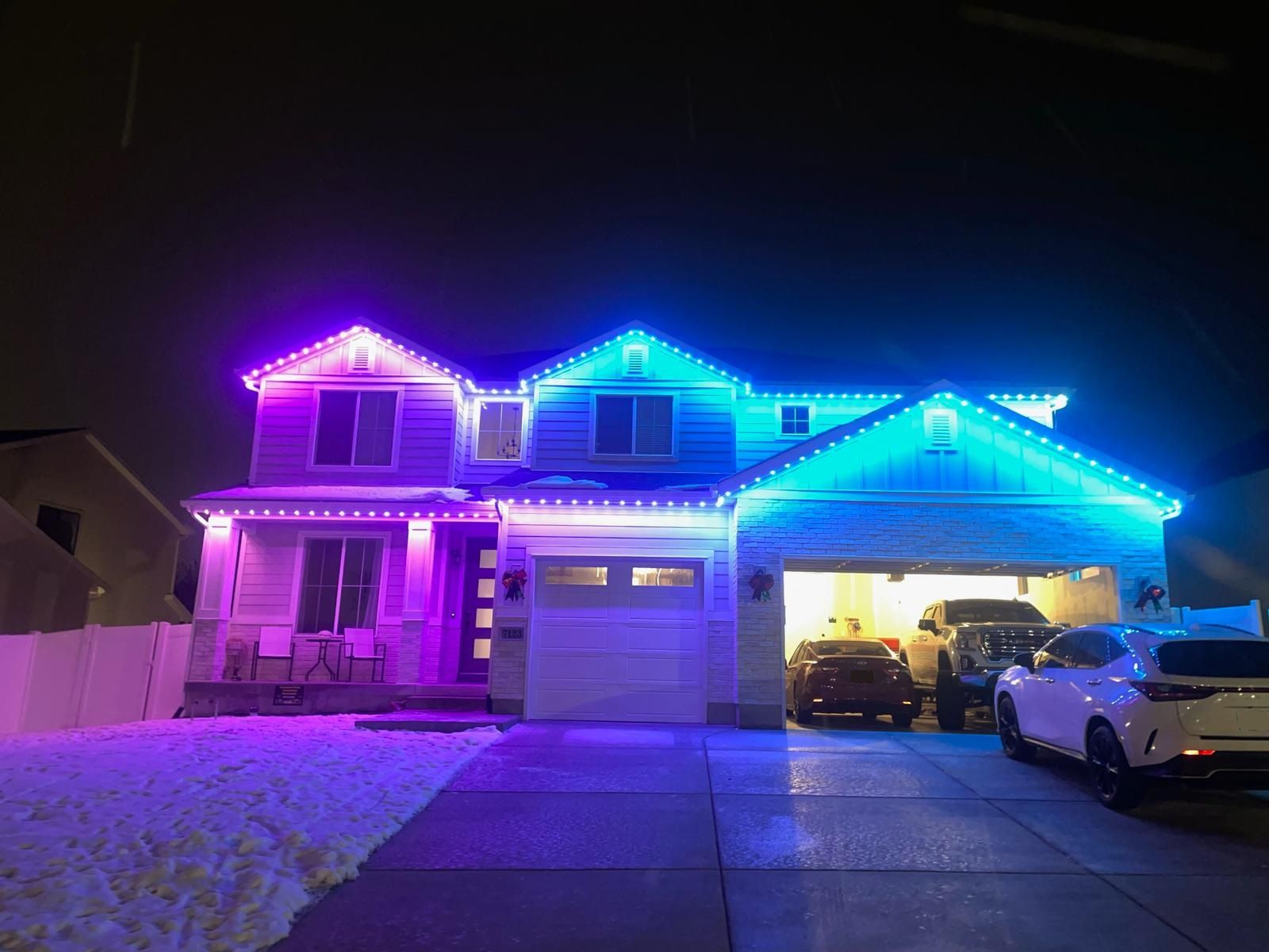 Calgary house with permanent soffit lights highlighting architectural features at dusk